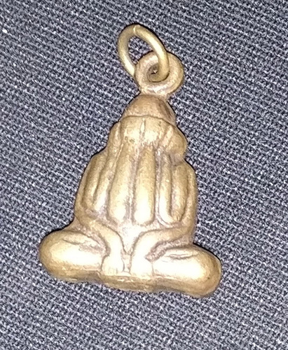 Closed eyed Buddha amulet
